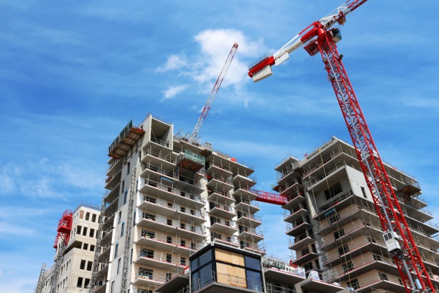 Photo of big apartment buildings under construction.