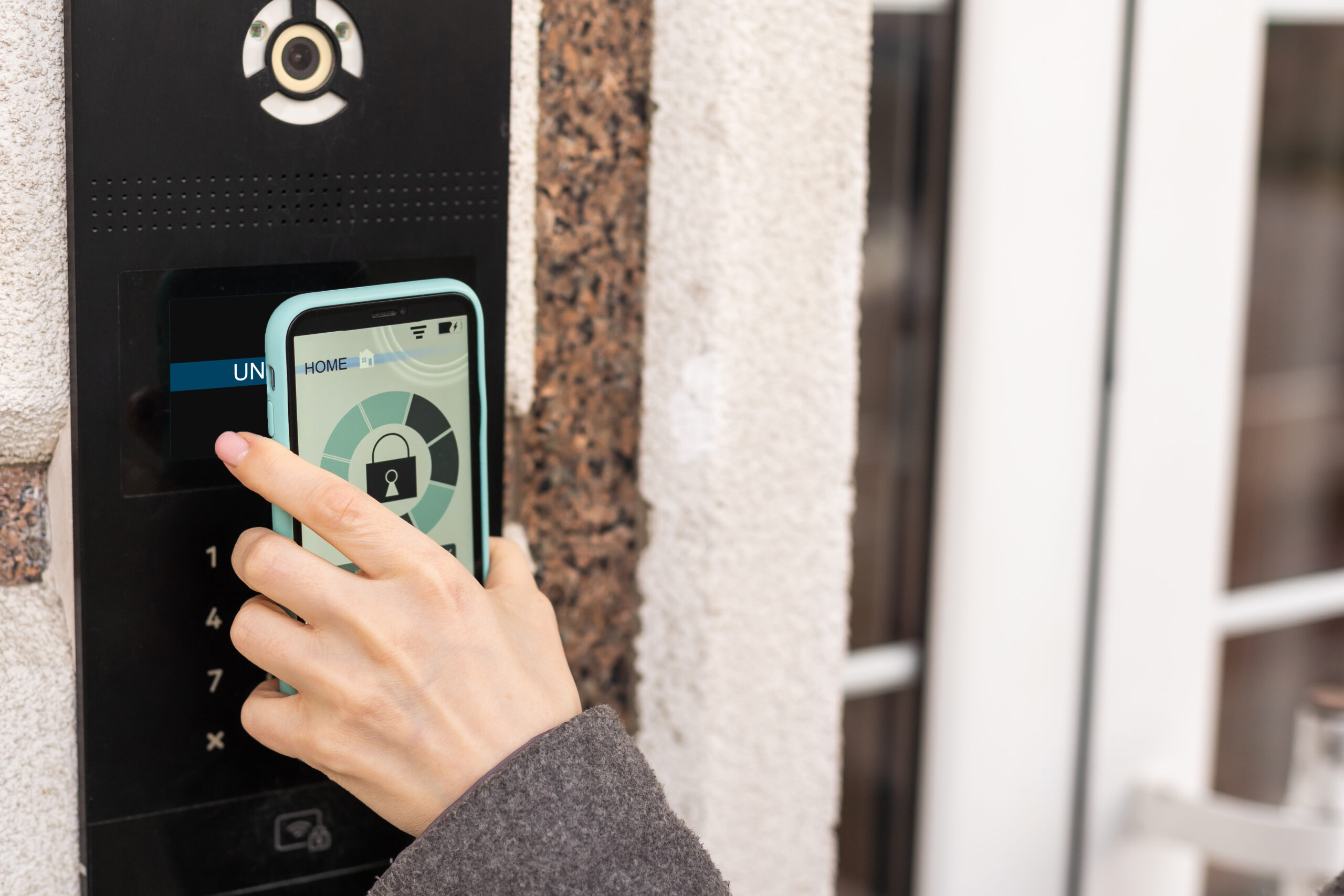 Photo of a phone unlocking a door keypad