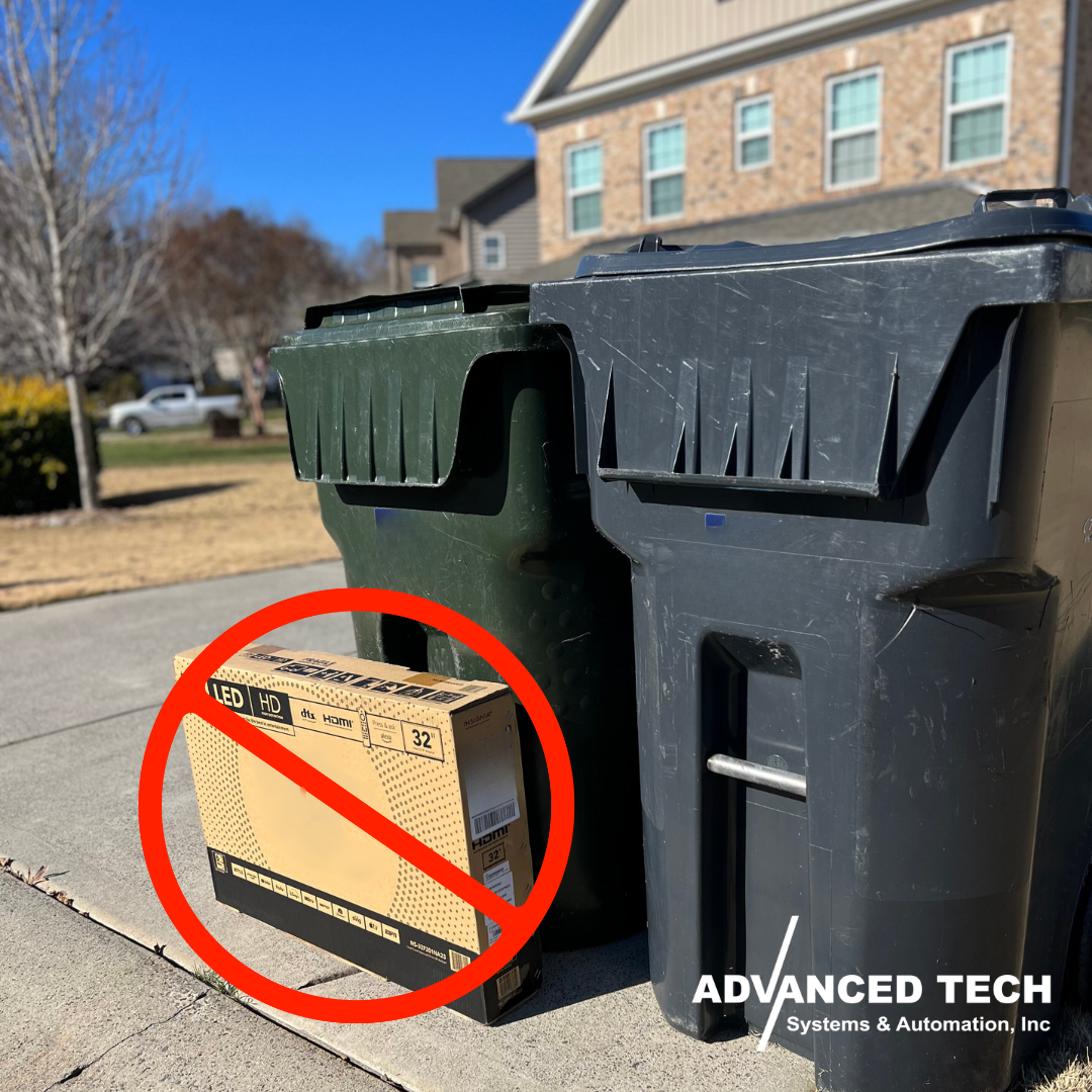 an image of a tv box left outside by the dumpsters 